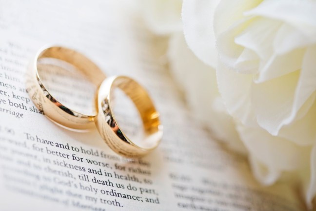Two wedding rings on a page of the Marriage Service
